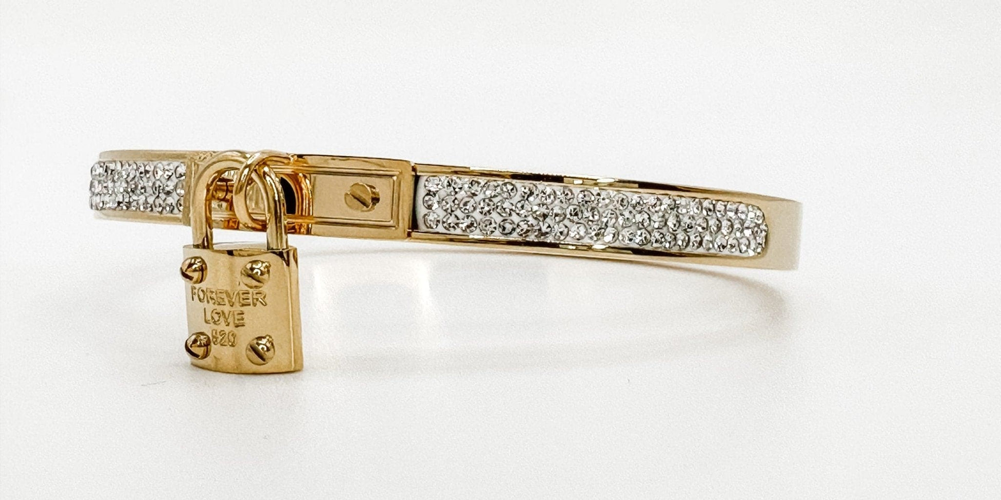 gold bangle bracelet with a lock charm