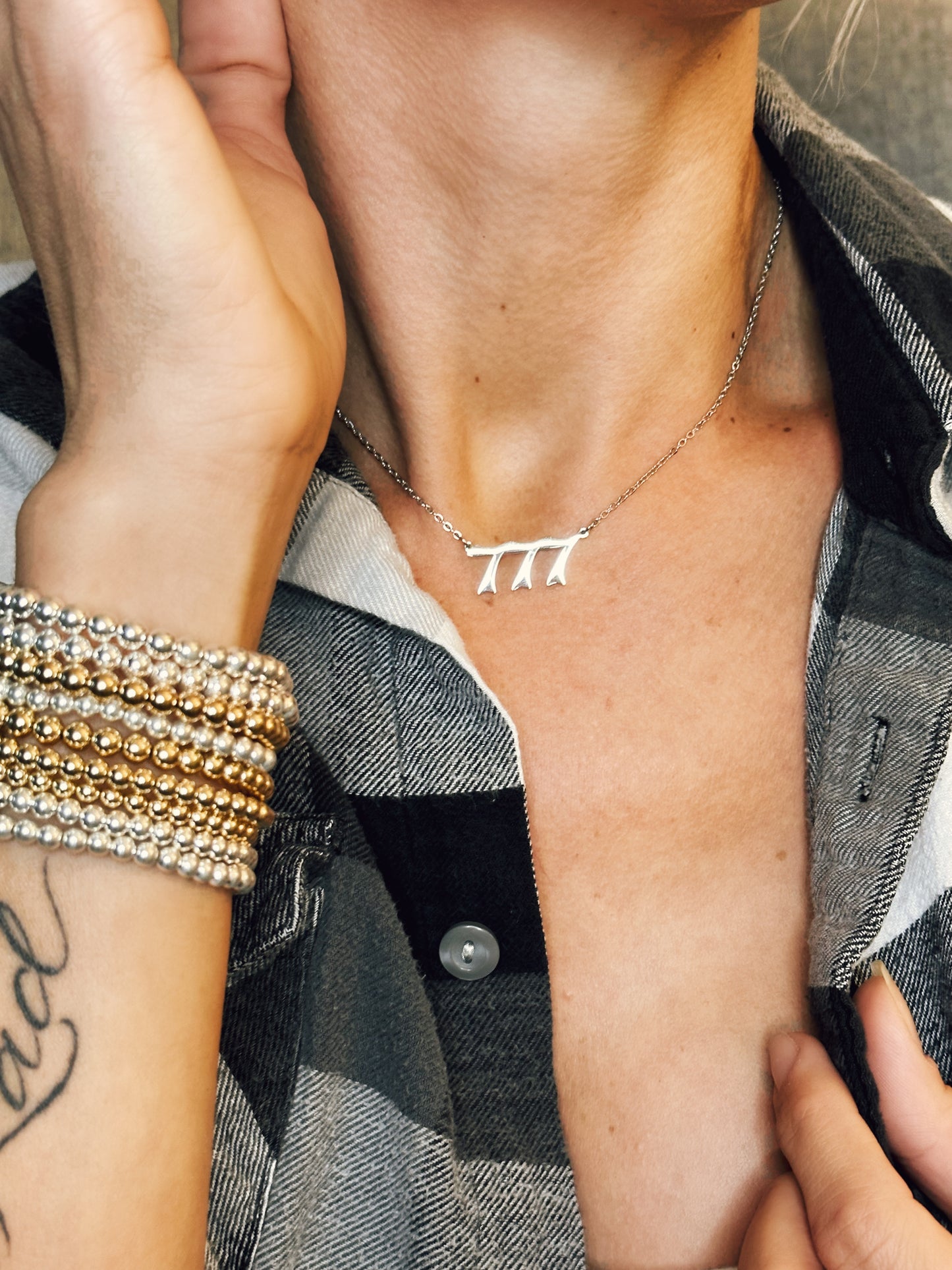 silver 777  necklace on model