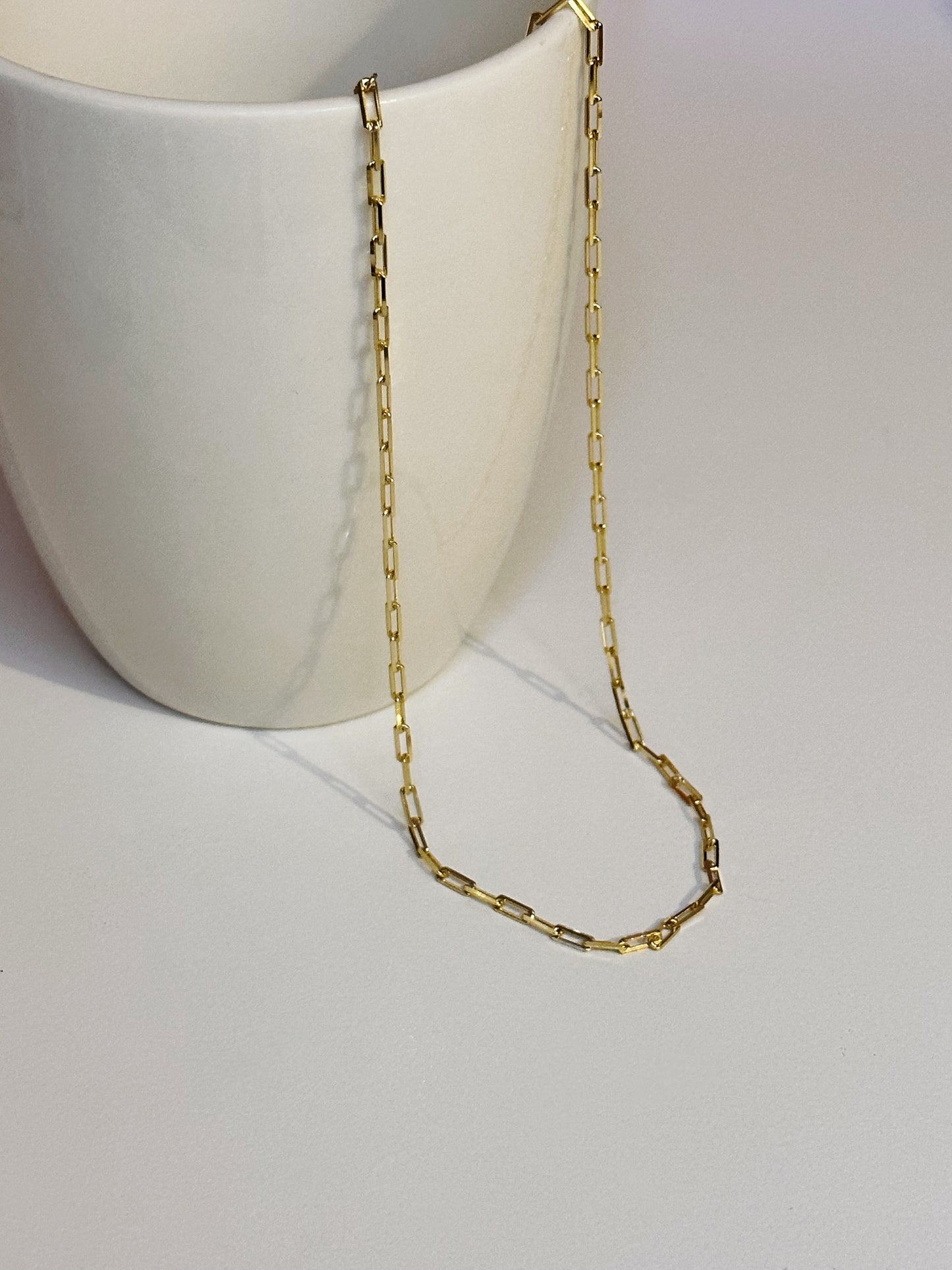 gold  paperclip chain  necklace in  white mug